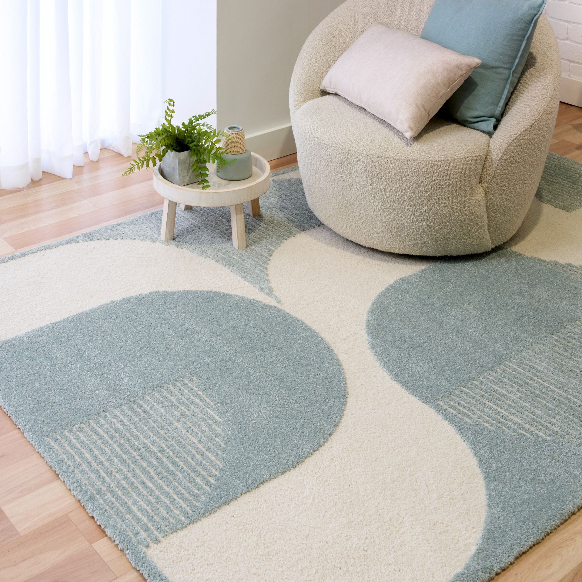 Osmond Waves Light Blue rug with soft geometric patterns in a neutral palette and a high-low textured finish. Colours Light Blue and Ivory. Sizes 160 X 230, 200 X 290 and 240 X 340. Life.