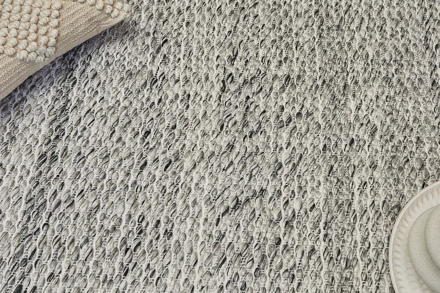 Oxford Grey is a hand-braided rug with a contemporary design. Crafted with wool and polyester for a textured feel, the rug has a pile height of 7-9mm. Colour White,Grey and Black. Sizes 160 X 230, 200 X 290, 240 X 340. Life.