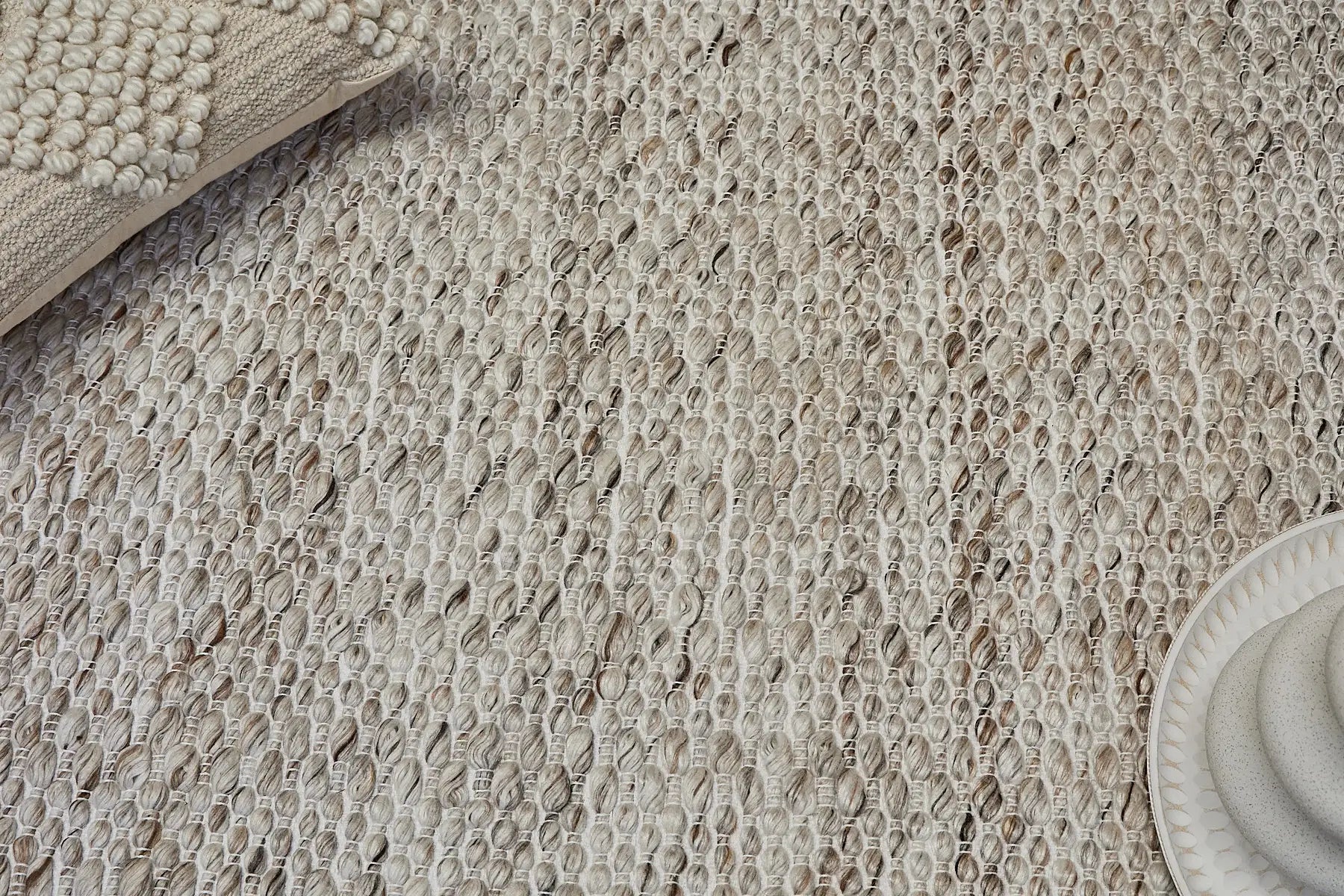Oxford Taupe is a hand-braided rug with a contemporary design. Crafted with wool and polyester for a textured feel, the rug has a pile height of 7-9mm. Colour Cream with brownish accents. Sizes 160 X 230, 200 X 290, 240 X 340 and 300 X 400. Life.