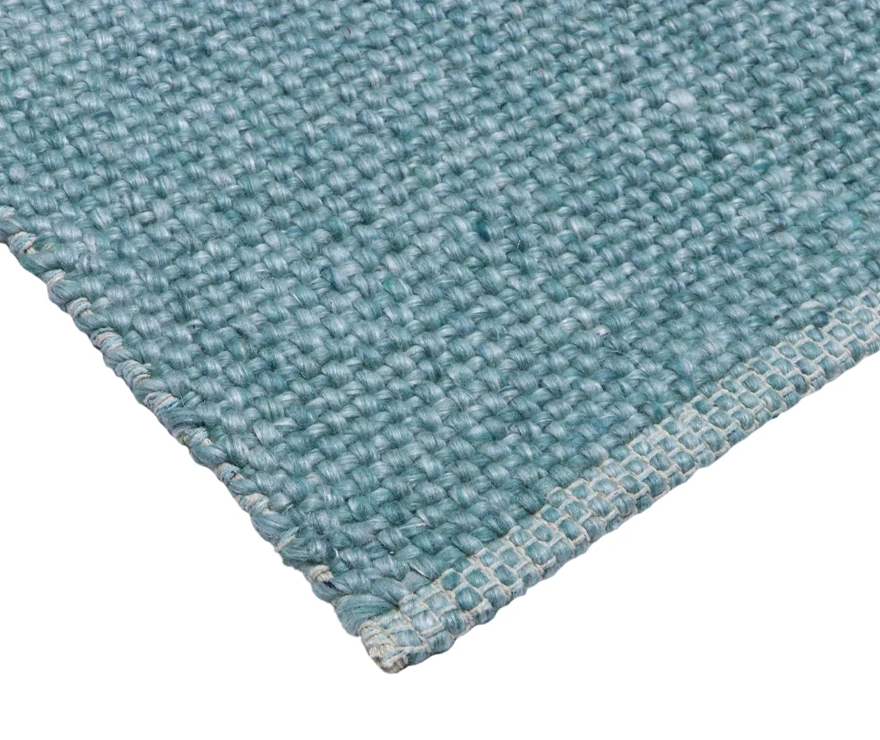 Pacific Green is a handwoven wool and polyester rug with a low-textured cross weave. It boasts a soft pile height of 7-9mm. Colour Aqua Green. Sizes 160 X 230, 200 X 290, 240 X 340 and 300 X 400. Corner.