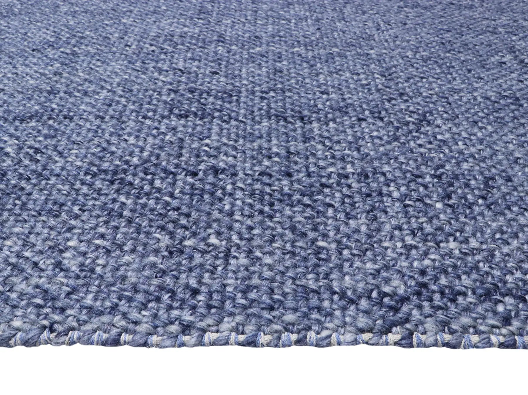 Pacific Navy is a handwoven wool and polyester rug with a low-textured cross weave. It boasts a soft pile height of 7-9mm. Colour Navy blue. Sizes 160 X 230, 200 X 290, 240 X 340 and 300 X 400. Side.