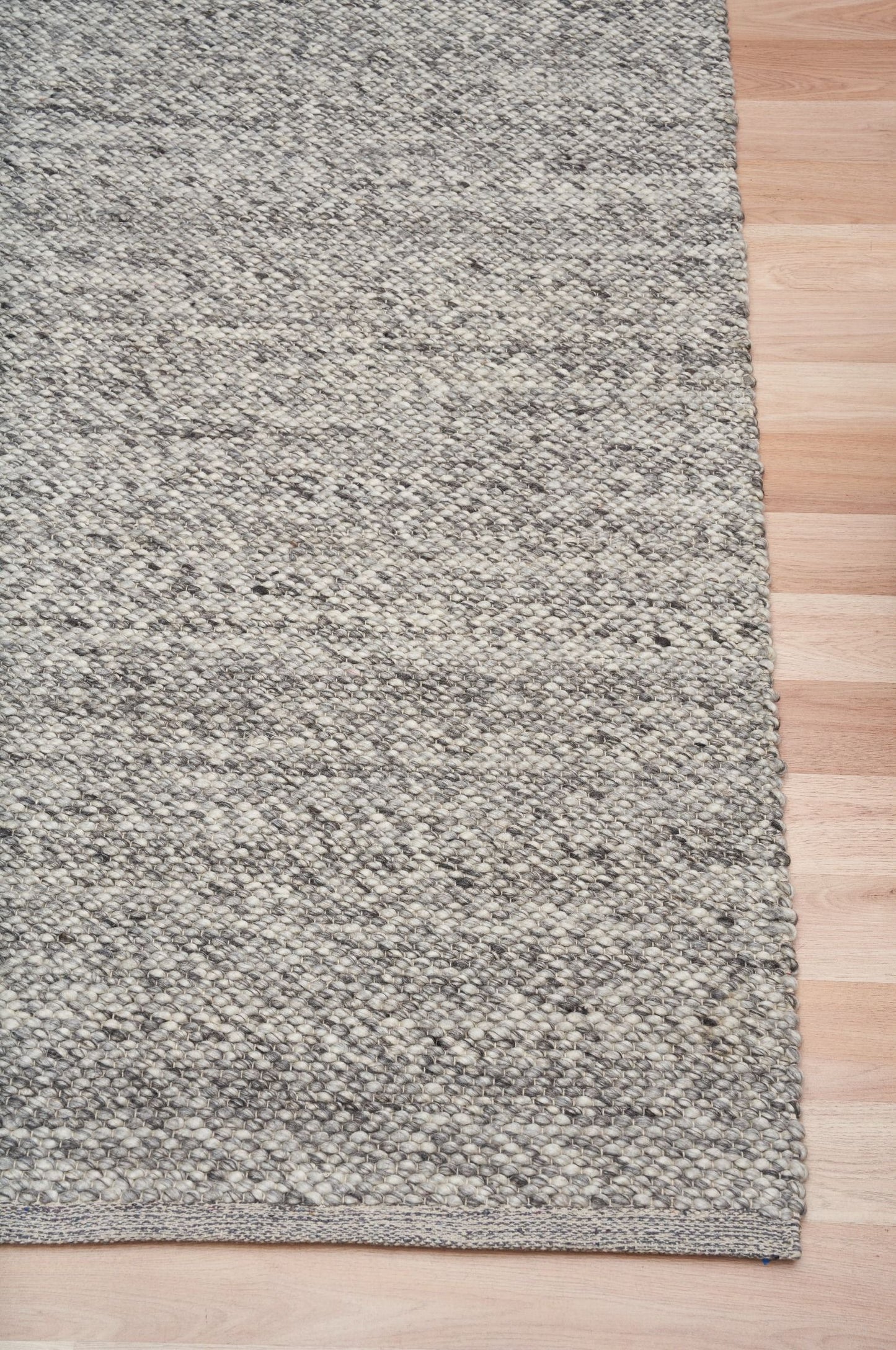 Park Lane Dark Grey is a contemporary hand woven flatweave rug. Made from 80%  New Zealand Wool and 20% polyester for a soft and slightly textured feel. Colour Dark Grey. Sizes 155 X 225, 200 X 290, 240 X 320 and 300 X 400. Corner.