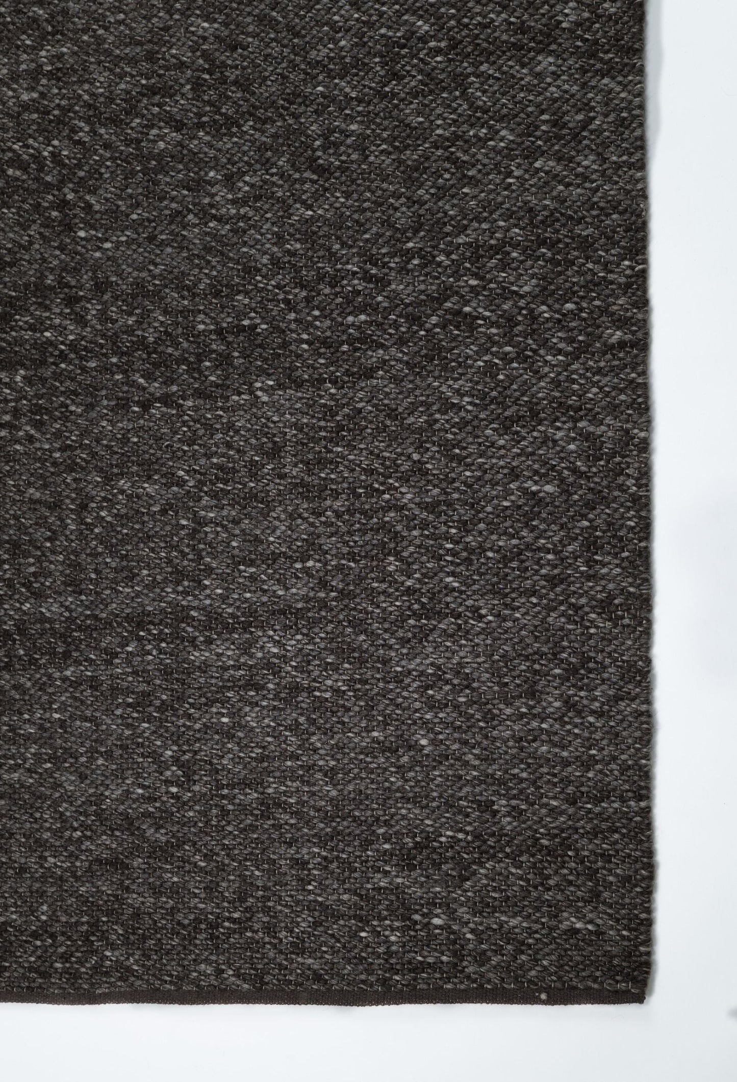 Park Lane Shadow is a contemporary hand woven flatweave rug. Made from 80%  New Zealand Wool and 20% polyester for a soft and slightly textured feel. Colour Blackish Grey. Sizes 155 X 225, 200 X 290, 240 X 320 and 300 X 400. Corner.