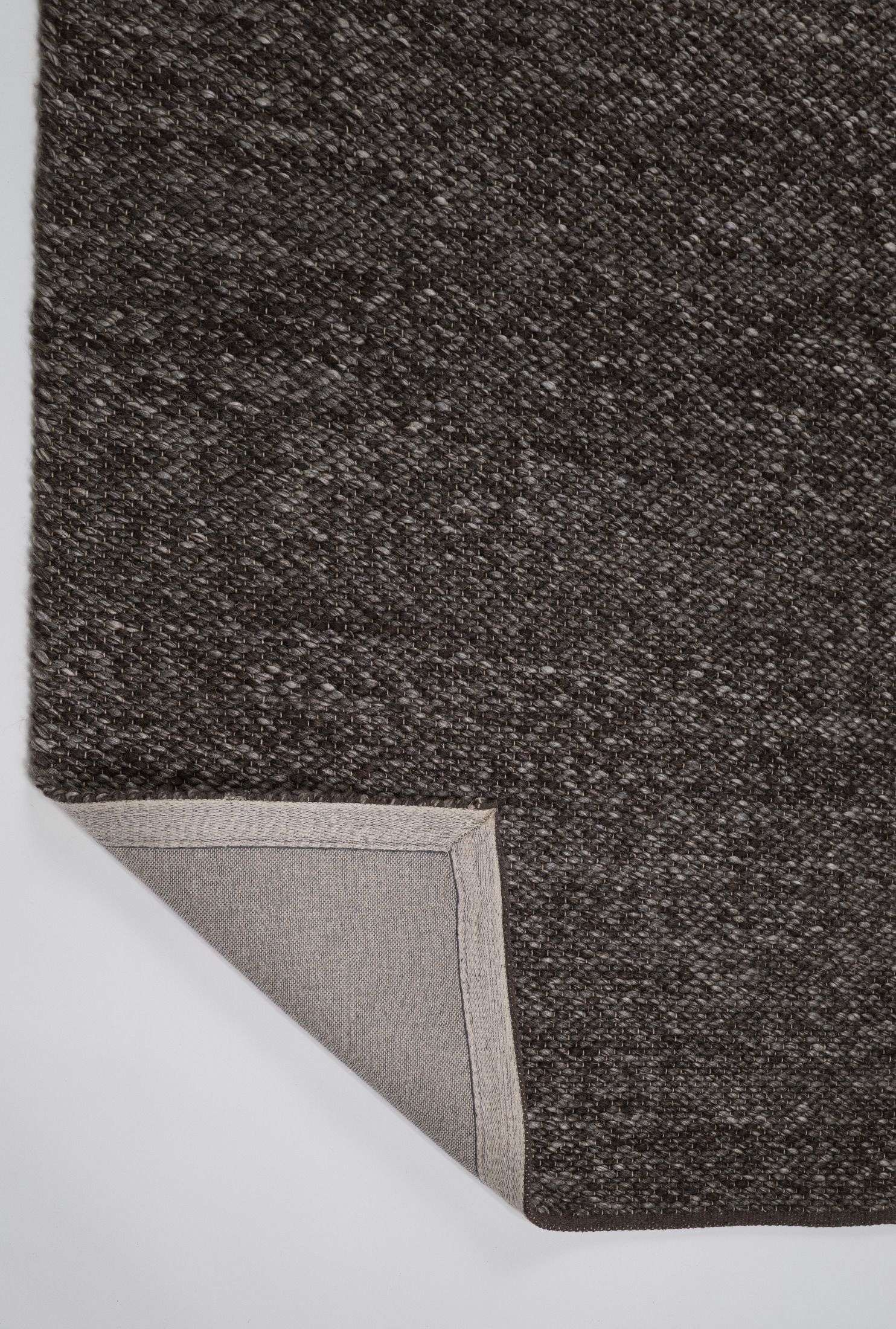 Park Lane Shadow is a contemporary hand woven flatweave rug. Made from 80%  New Zealand Wool and 20% polyester for a soft and slightly textured feel. Colour Blackish Grey. Sizes 155 X 225, 200 X 290, 240 X 320 and 300 X 400. Fold.