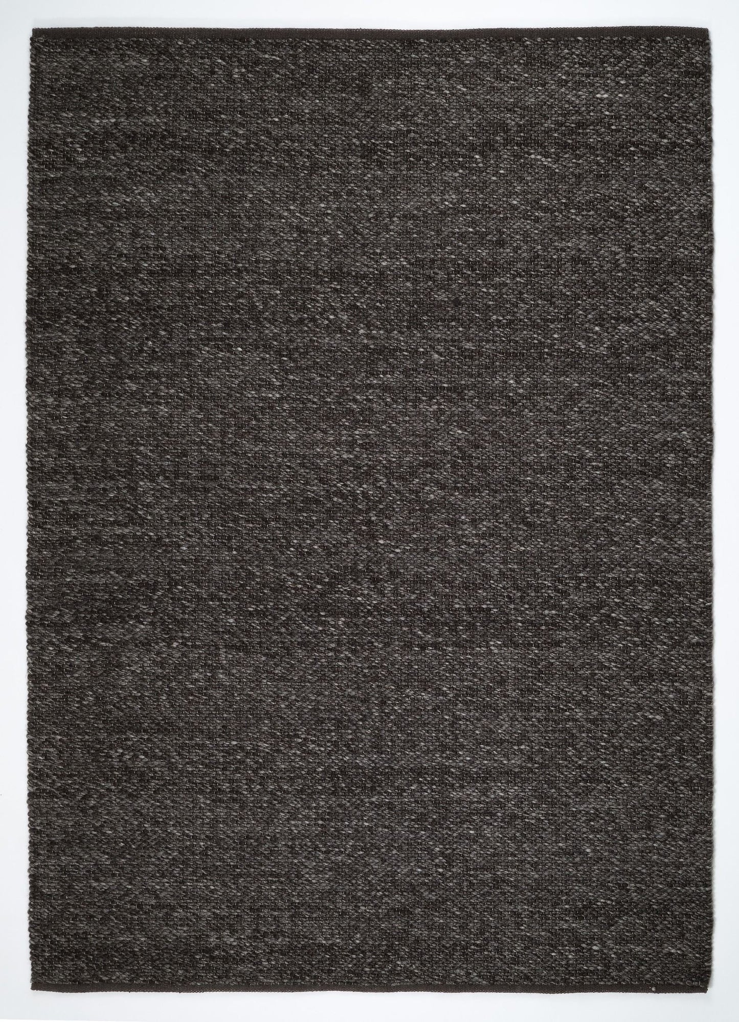 Park Lane Shadow is a contemporary hand woven flatweave rug. Made from 80%  New Zealand Wool and 20% polyester for a soft and slightly textured feel. Colour Blackish Grey. Sizes 155 X 225, 200 X 290, 240 X 320 and 300 X 400. Full.