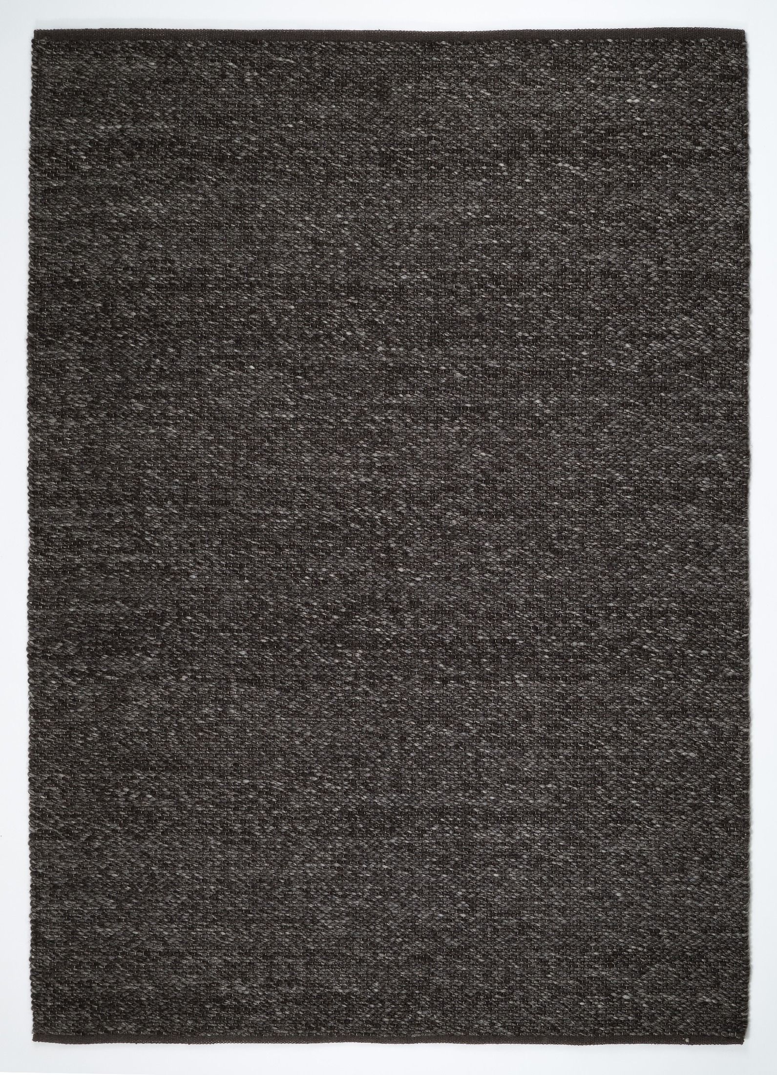 Park Lane Shadow is a contemporary hand woven flatweave rug. Made from 80%  New Zealand Wool and 20% polyester for a soft and slightly textured feel. Colour Blackish Grey. Sizes 155 X 225, 200 X 290, 240 X 320 and 300 X 400. Full.