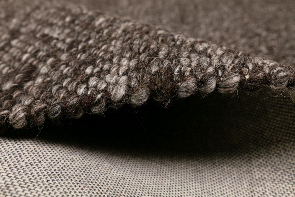 Park Lane Shadow is a contemporary hand woven flatweave rug. Made from 80%  New Zealand Wool and 20% polyester for a soft and slightly textured feel. Colour Blackish Grey. Sizes 155 X 225, 200 X 290, 240 X 320 and 300 X 400. Side