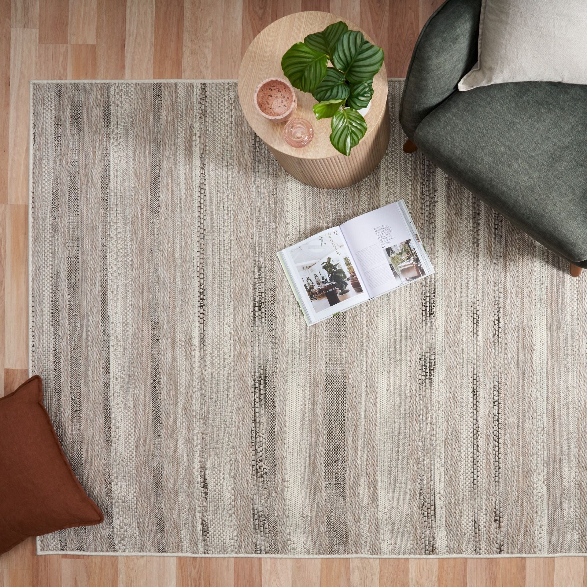 The Patio Linear Linen indoor/outdoor rug featuring neutral tones and a subtle textured pattern, power-loomed from UV-stabilised polypropylene for lasting durability. Colours, Linen, Beiges and hints of black. 3 sizes. Life.