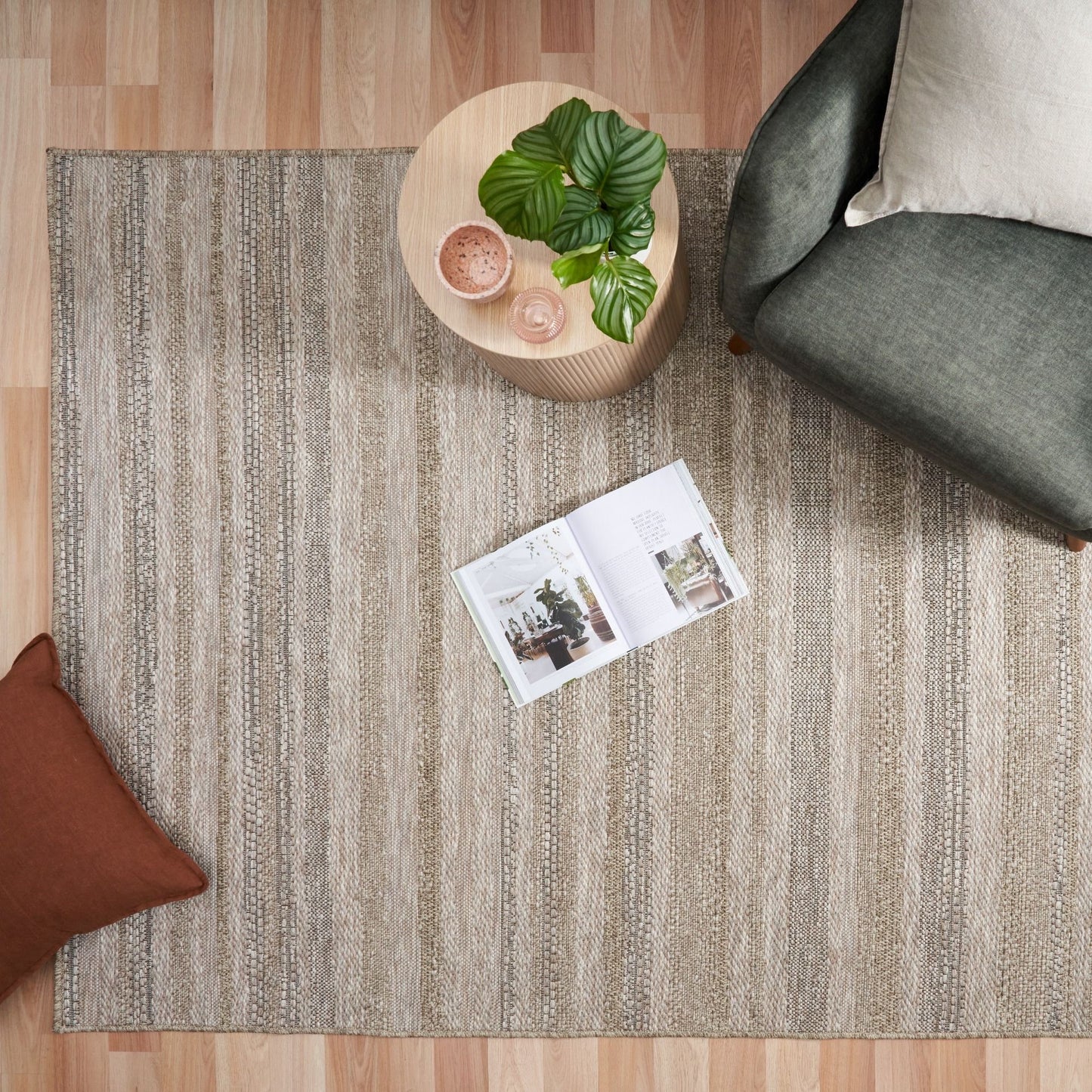 The Patio Linear Straw indoor/outdoor rug featuring neutral tones and a subtle textured pattern, power-loomed from UV-stabilised polypropylene for lasting durability. Colour Browns, Beiges and hints of black. 3 sizes. Life.