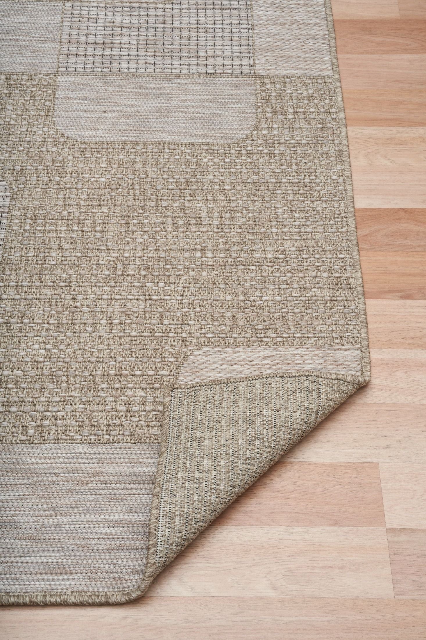 The Patio Squares Straw indoor/outdoor rug featuring neutral tones and a modern designed pattern, power-loomed from UV-stabilised polypropylene for lasting durability. Colours, Linen, Beiges and hints of light grey. 3 sizes. Fold.