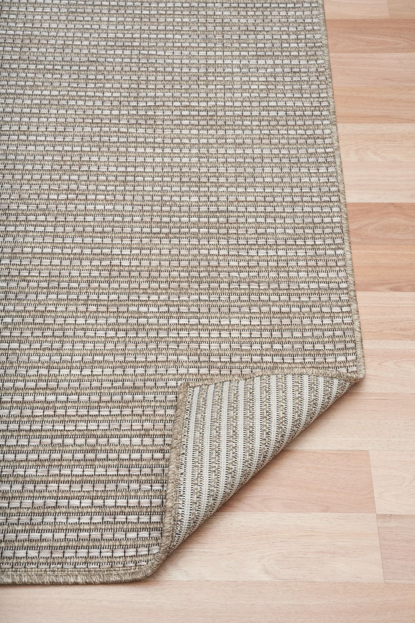 The Patio Straw 20721 indoor/outdoor rug featuring neutral tones and a modern designed pattern, power-loomed from UV-stabilised polypropylene for lasting durability. Colours Greys, Beiges and hints of light grey. 3 sizes. Fold.
