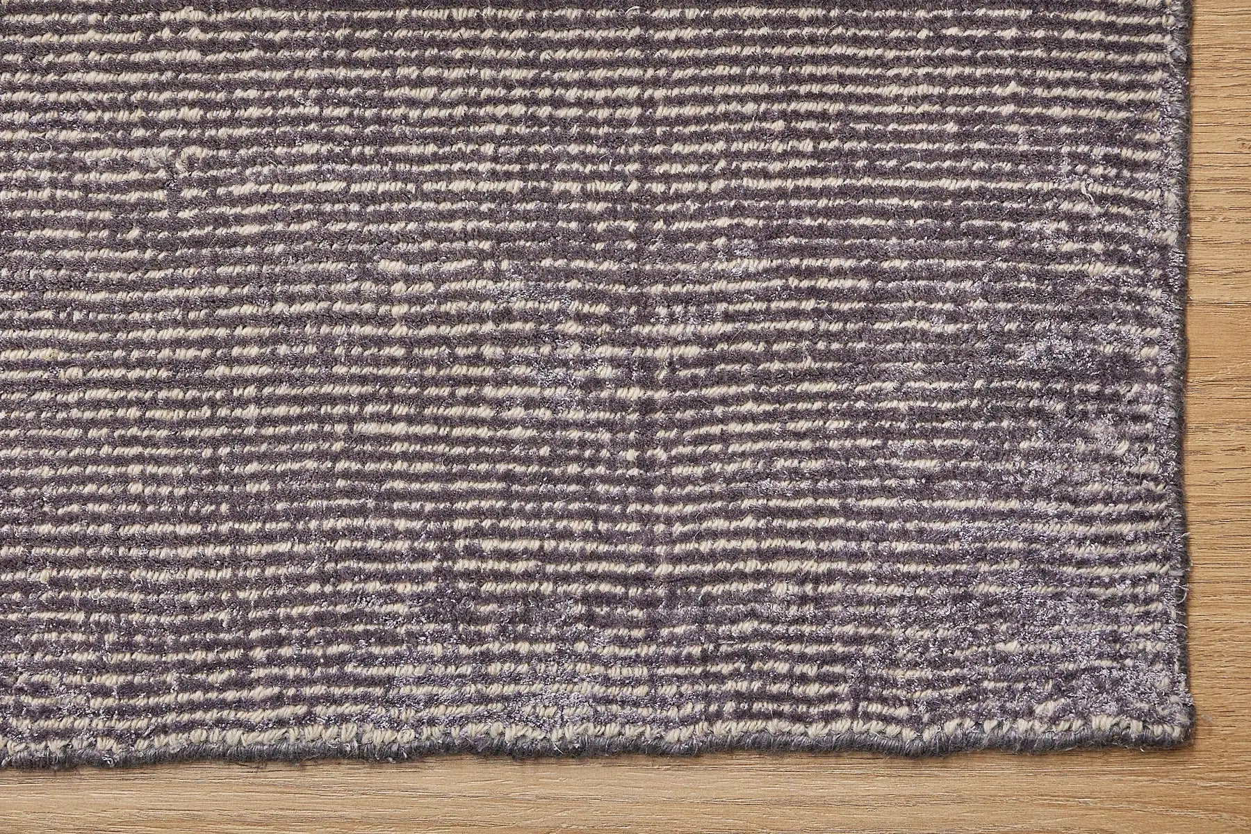 Pearl Garnet is a luxurious hand-loomed knotted rug made with wool and silky viscose. It boasts a ribbed texture and pile height of 12-14mm. Colour Blueish Grey with Beige accents. Sizes 160 X 230, 200 X 290 and 240 X 340. Corner.