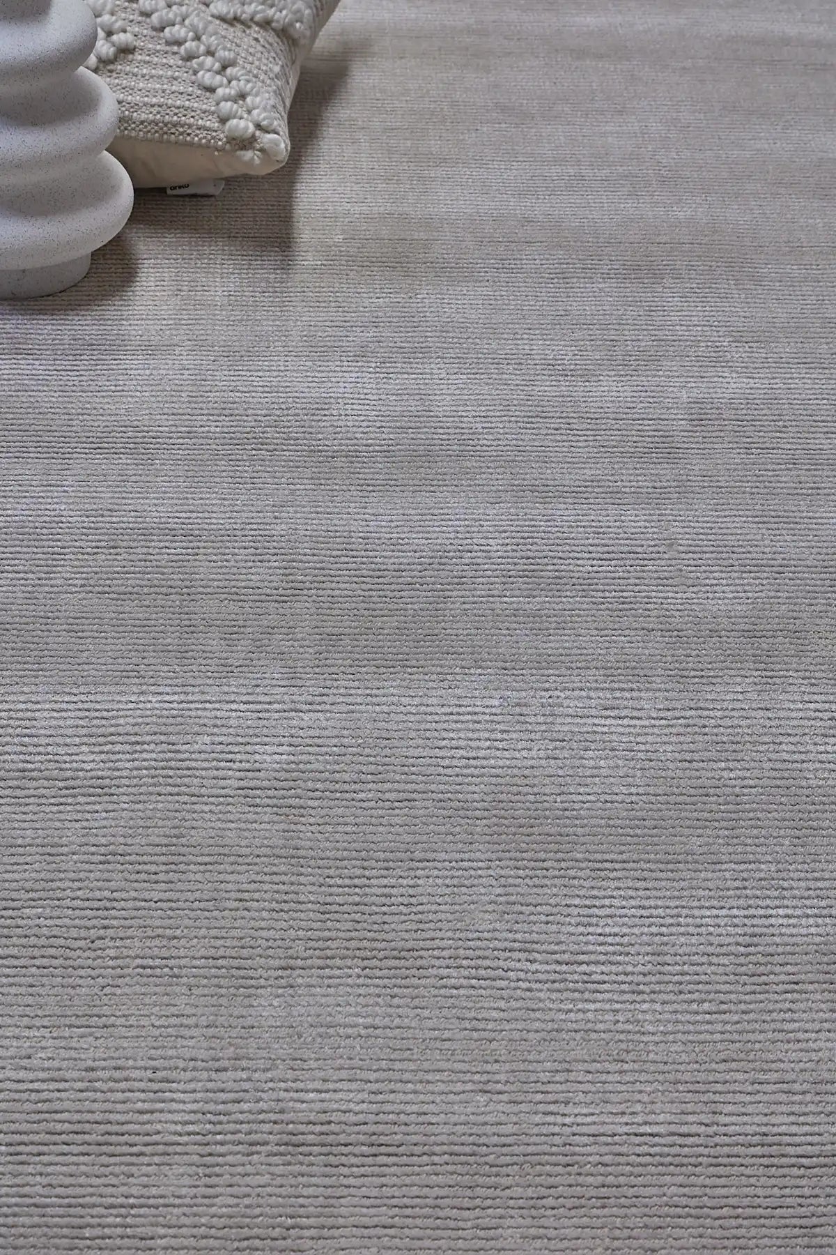 Pearl Grace is a luxurious hand-loomed knotted rug made with wool and silky viscose. It boasts a ribbed texture and pile height of 12-14mm. Colour Silver Grey. Sizes 160 X 230, 200 X 290 and 240 X 340. Life.