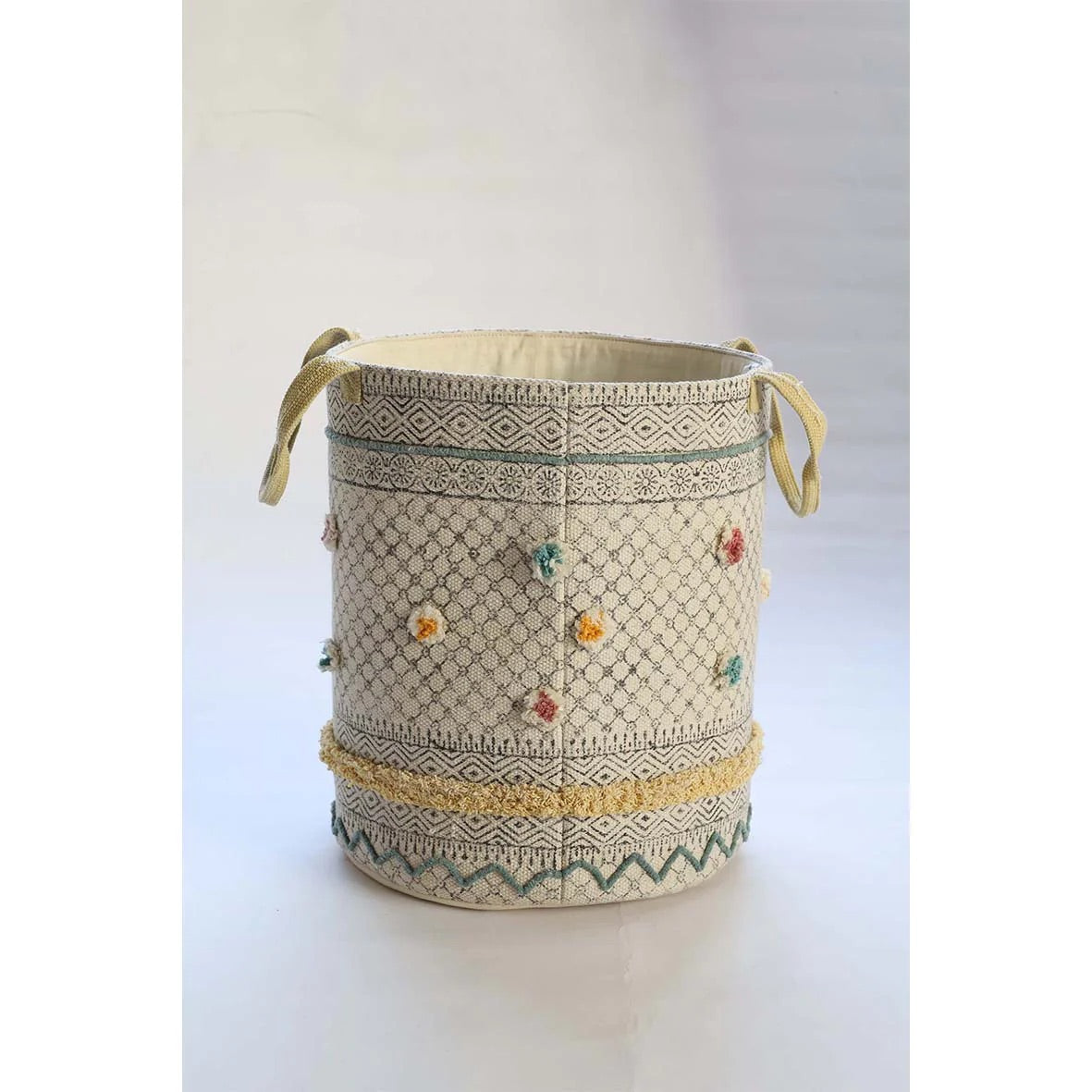 The Pearled Cotton Block Print Basket, boasts a bold motif block print design and 2 handles. Featuring an interior cotton lining and an outer textured cotton cover.  Colours, creams, dark blues, yellows and browns. Size 400 height X 350 diameter. Side Plain.
