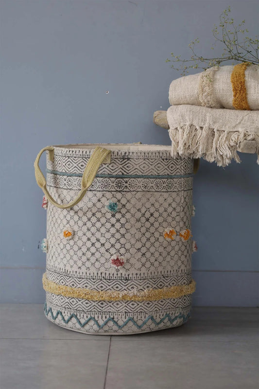The Pearled Cotton Block Print Basket, boasts a bold motif block print design and 2 handles. Featuring an interior cotton lining and an outer textured cotton cover.  Colours, creams, dark blues, yellows and browns. Size 400 height X 350 diameter. Front Styled.
