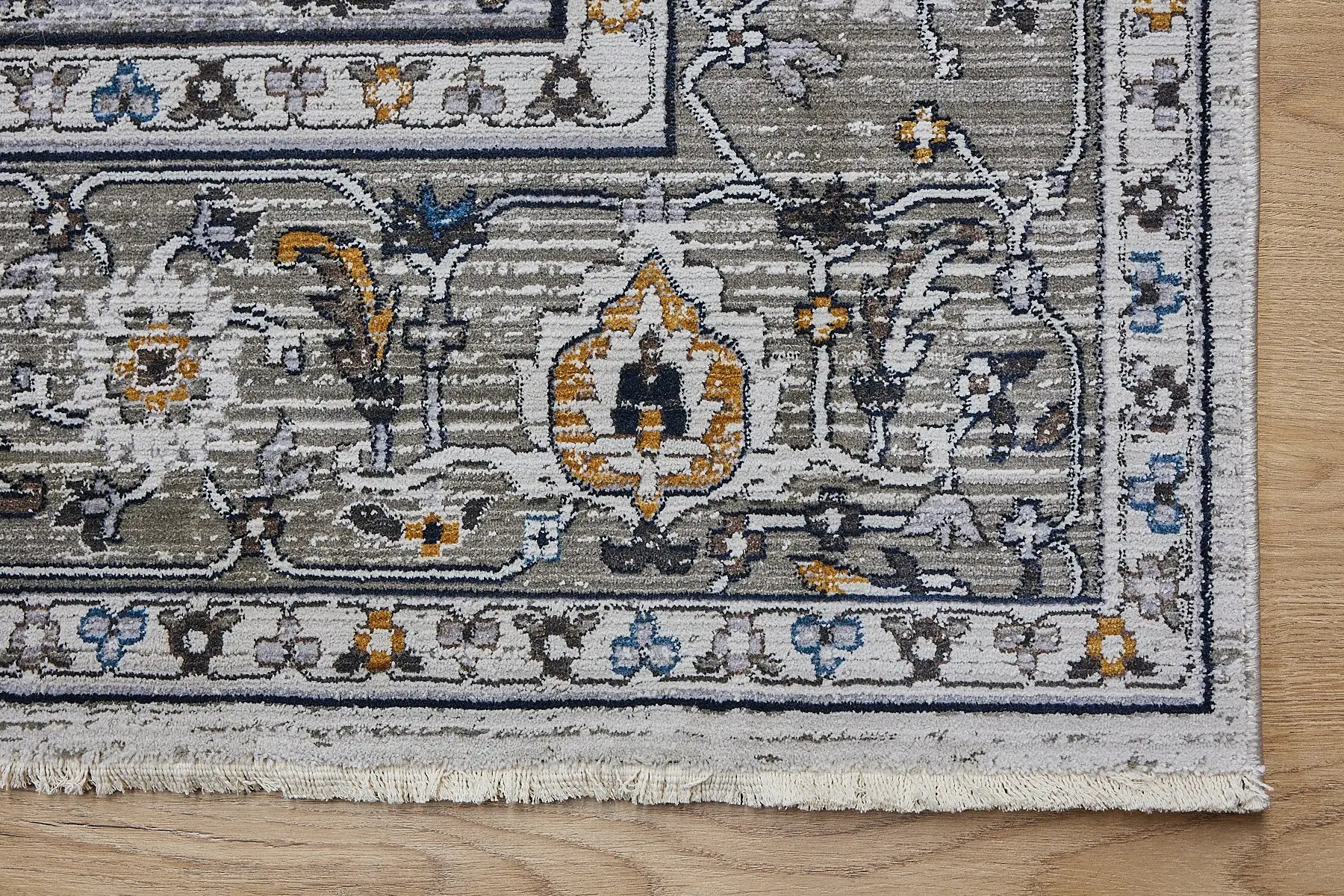 Persia Taupe is a machine made traditional designed rug crafted from luxurious polyester for soft feel.  It has a 7-9mm Pile height. Colours grey with beige and blue accents. Sizes 160 X 230, 200 X 290, 240 X 340 and 300 X 400. Corner.