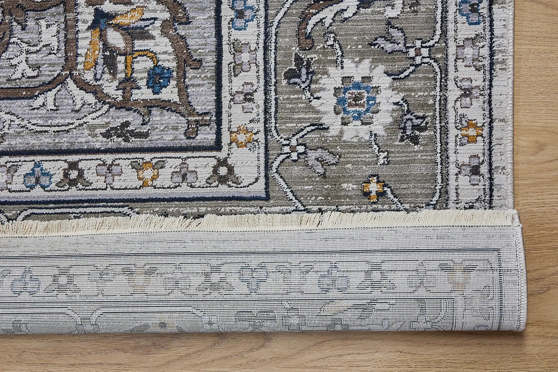 Persia Taupe is a machine made traditional designed rug crafted from luxurious polyester for soft feel.  It has a 7-9mm Pile height. Colours grey with beige and blue accents. Sizes 160 X 230, 200 X 290, 240 X 340 and 300 X 400. Fold.