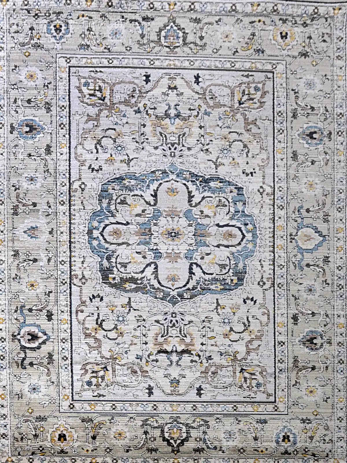 Persia Taupe is a machine made traditional designed rug crafted from luxurious polyester for soft feel.  It has a 7-9mm Pile height. Colours grey with beige and blue accents. Sizes 160 X 230, 200 X 290, 240 X 340 and 300 X 400. Full.