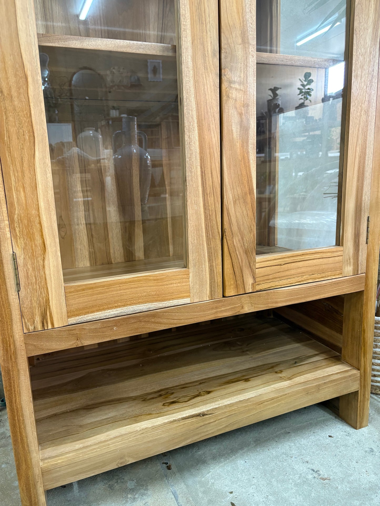 The Pisces Cabinet. Crafted from A grade teak featuring 2 glass doors and 1 lower shelf. Colour Natural. Measures 1700H x 450D x 800W. Bottom.