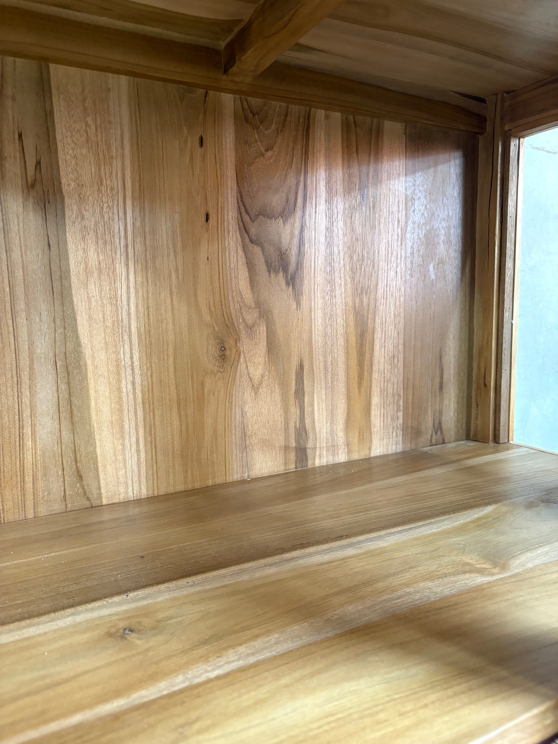 The Pisces Cabinet. Crafted from A grade teak featuring 2 glass doors and 1 lower shelf. Colour Natural. Measures 1700H x 450D x 800W. Inside.