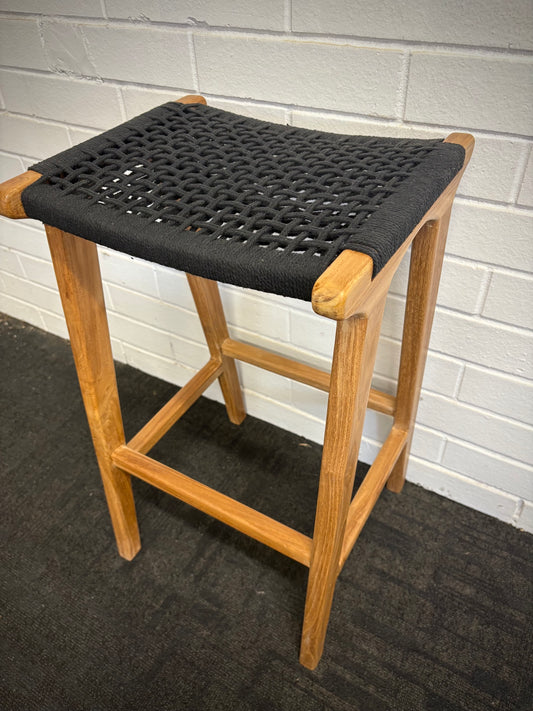 The Rio Grande Barstool boasts a coastal contemporary feel. Crafted from sustainable solid teak and featuring a macrame rope seat. Colour natural frame with black seat. Measures 400 wide X 350 depth X 670 seat height. Angle.