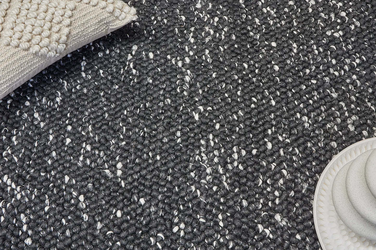 Rocks Black is a luxurious hand-woven wool carpet. Boasting a plush loop pile with 8-18mm pile height. Colour Black with white accents. Sizes 160 X 230, 200 X 290, 240 X 340 and 290 X 390. Life.