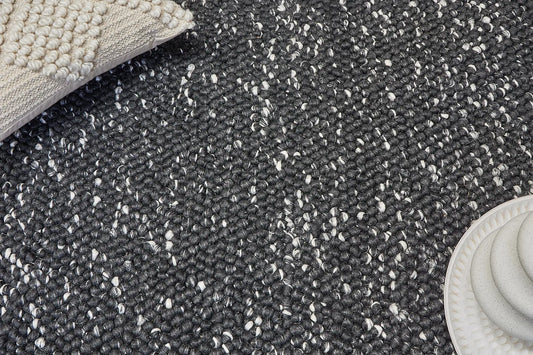 Rocks Black is a luxurious hand-woven wool carpet. Boasting a plush loop pile with 8-18mm pile height. Colour Black with white accents. Sizes 160 X 230, 200 X 290, 240 X 340 and 290 X 390. Life.