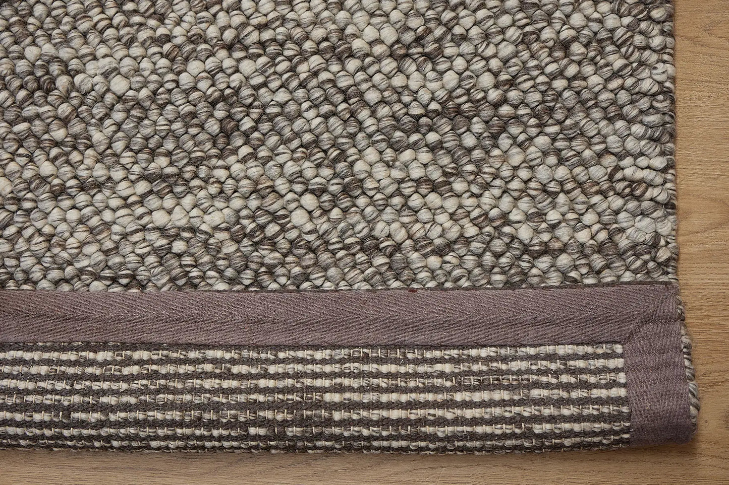 Rocks Brown is a luxurious hand-woven wool carpet. Boasting a plush loop pile with 8-18mm pile height. Colour Brown with beige accents. Sizes 160 X 230, 200 X 290, 240 X 340 and 290 X 390. Fold.