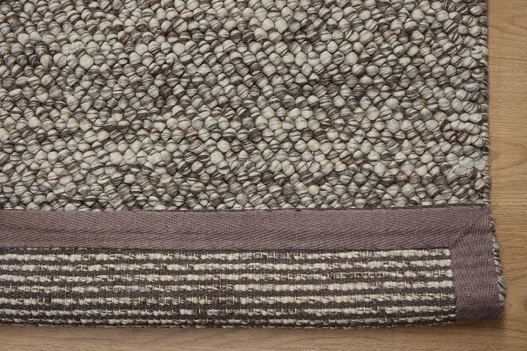 Rocks Brown is a luxurious hand-woven wool carpet. Boasting a plush loop pile with 8-18mm pile height. Colour Brown with beige accents. Sizes 160 X 230, 200 X 290, 240 X 340 and 290 X 390. Fold.