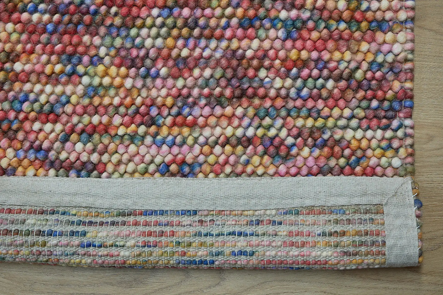 Rocks Multi is a luxurious hand-woven wool carpet. Boasting a plush loop pile with 8-18mm pile height. Colour Multi coloured. Sizes 160 X 230, 200 X 290, 240 X 340 and 290 X 390. Fold.