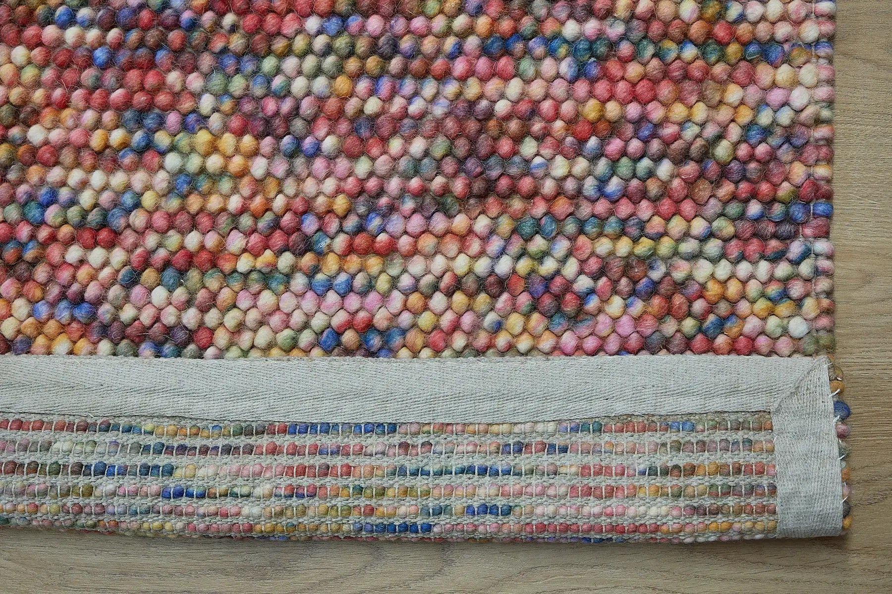 Rocks Multi is a luxurious hand-woven wool carpet. Boasting a plush loop pile with 8-18mm pile height. Colour Multi coloured. Sizes 160 X 230, 200 X 290, 240 X 340 and 290 X 390. Fold.