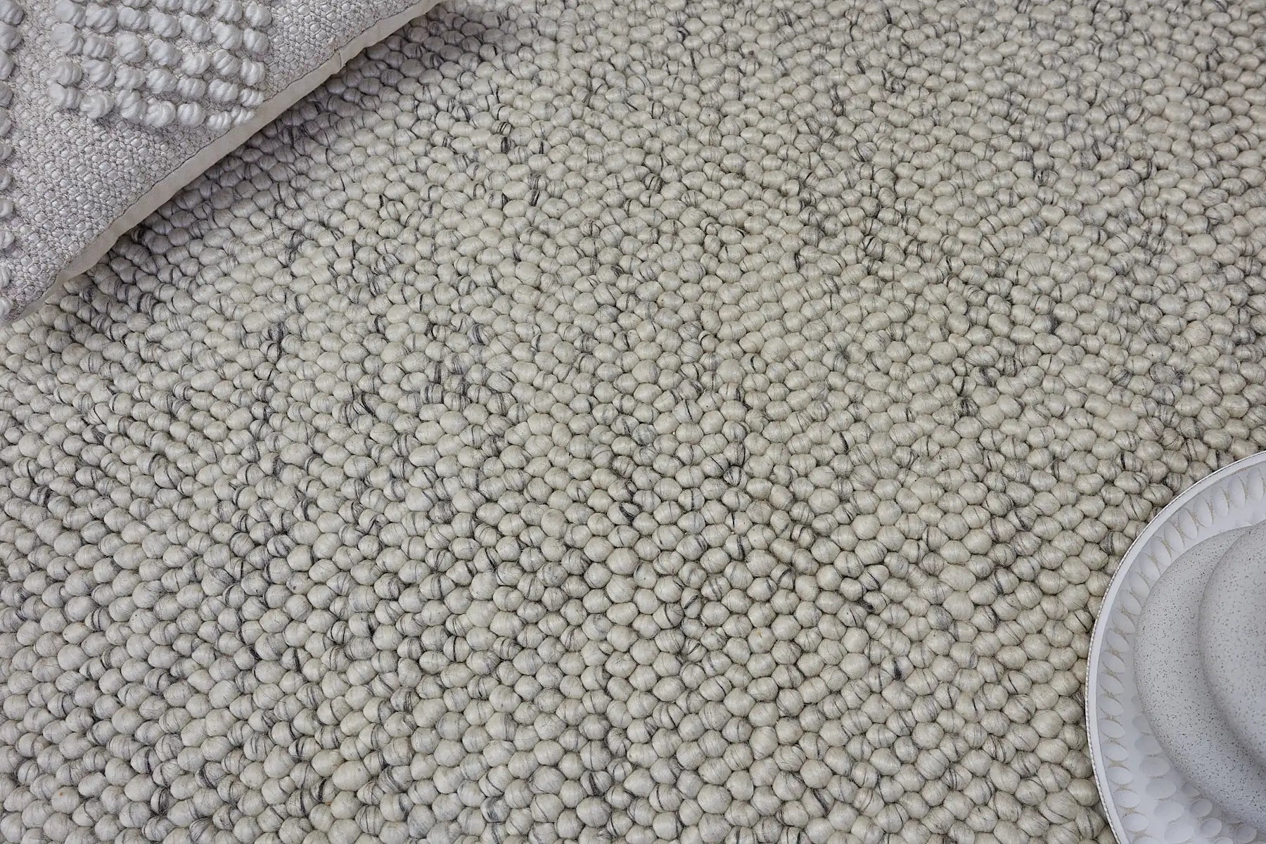 Rocks White is a luxurious hand-woven wool carpet. Boasting a plush loop pile with 8-18mm pile height. Colour White with grey accents. Sizes 160 X 230, 200 X 290, 240 X 340 and 290 X 390. Life.