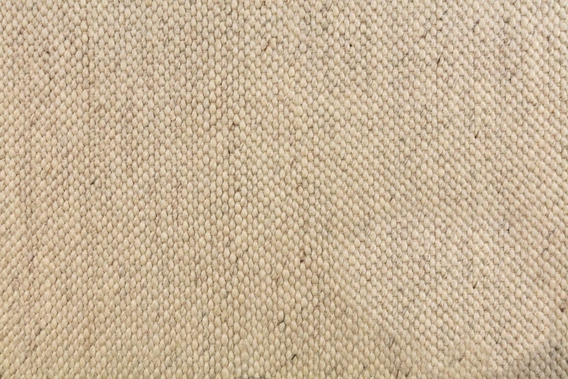 Close view of a hand woven wool flatweave rug.