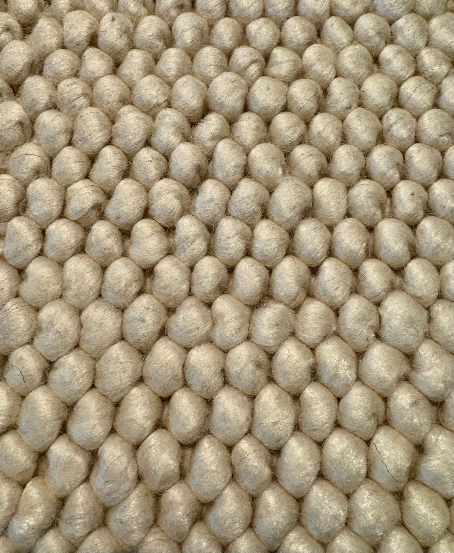 Rusta Cream hand-woven wool rug featuring a looped pile textured design in soft neutral cream tones, ideal for modern and contemporary interiors. Sizes 155 X 225, 200 X 290, 240 X 320 and 300 X 400. Fibres Close.