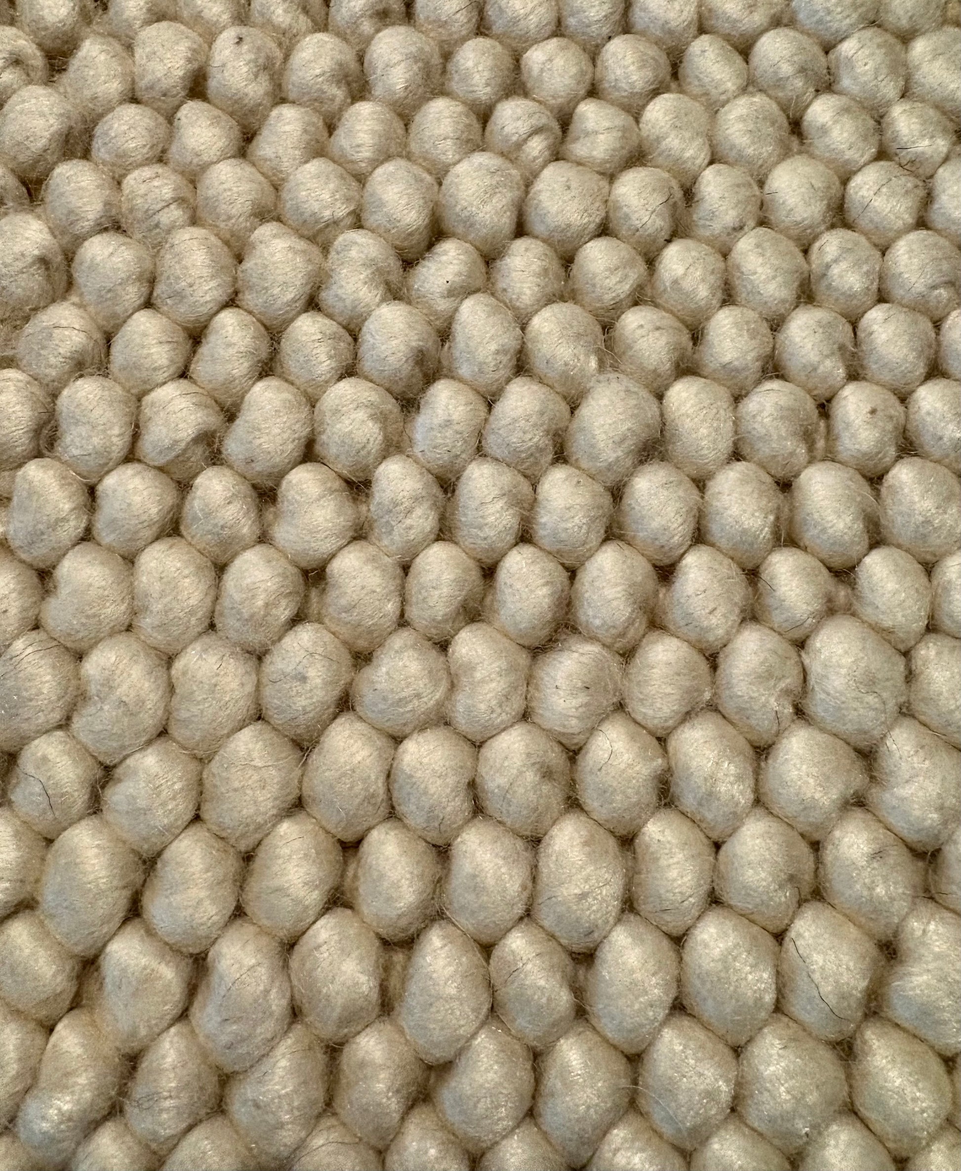 Rusta Cream hand-woven wool rug featuring a looped pile textured design in soft neutral cream tones, ideal for modern and contemporary interiors. Sizes 155 X 225, 200 X 290, 240 X 320 and 300 X 400. Fibres Close.