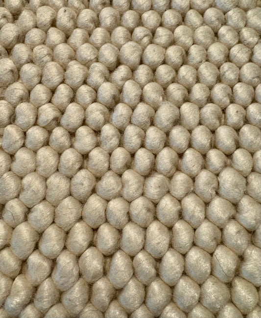 Rusta Cream hand-woven wool rug featuring a looped pile textured design in soft neutral cream tones, ideal for modern and contemporary interiors. Sizes 155 X 225, 200 X 290, 240 X 320 and 300 X 400. Fibres Close.