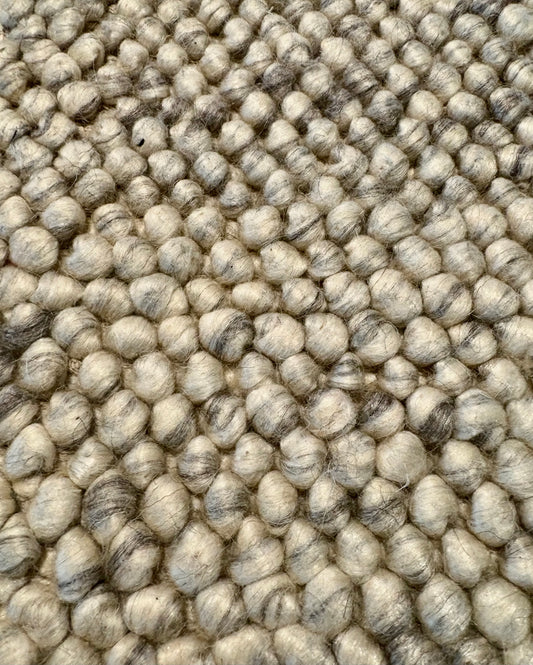 Rusta Silver hand-woven wool rug featuring a looped pile textured design in soft silver tones, ideal for modern and contemporary interiors. Sizes 155 X 225, 200 X 290, 240 X 320 and 300 X 400. Fibres Close.