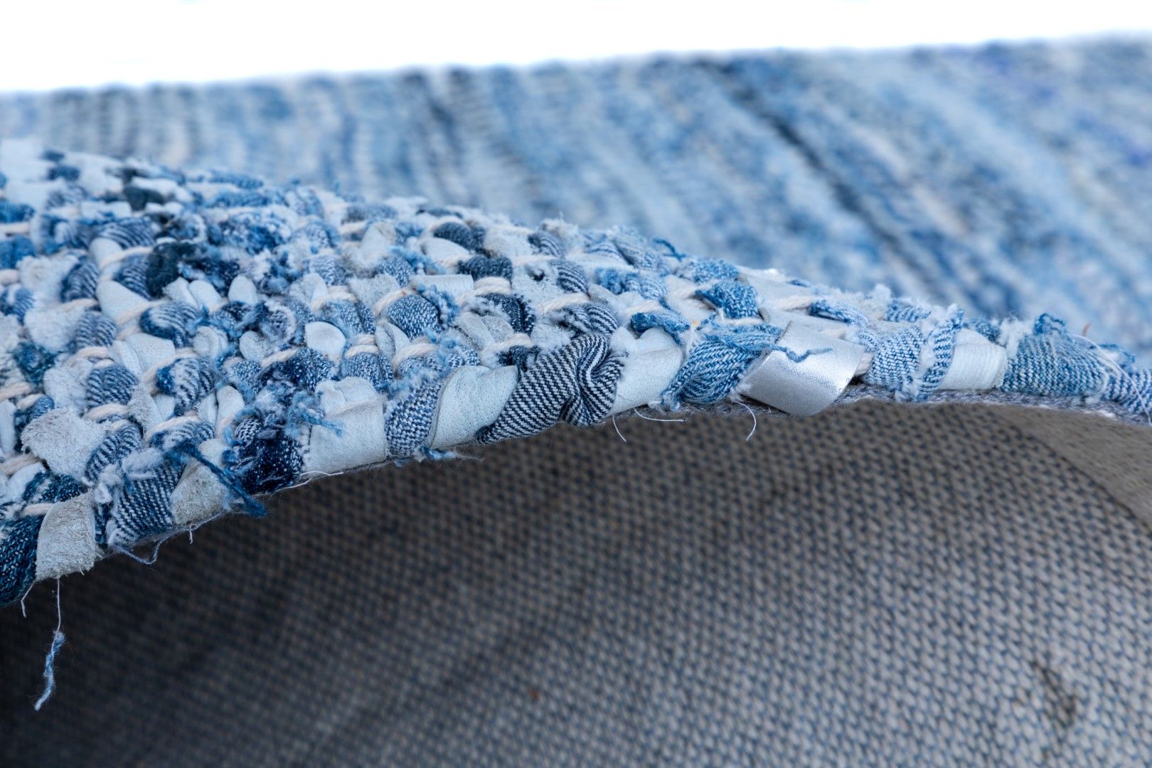 Rustic Charm Blue is a hand woven natural jute and leather carpet.  Colour Light Blue and Blue. Sizes 155 X 225, 200 X 290, 240 X 320 and 300 X 400. Side.