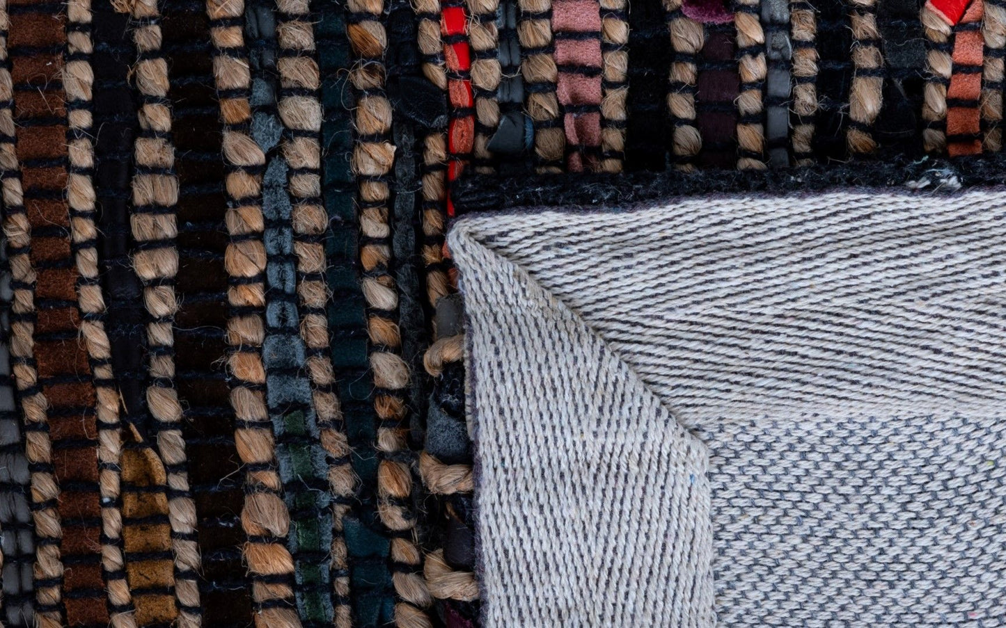 Rustic Charm Multi is a hand woven natural jute and leather carpet.  Colour Black with a multi colour accents. Sizes 155 X 225, 200 X 290, 240 X 320 and 300 X 400. Fold.