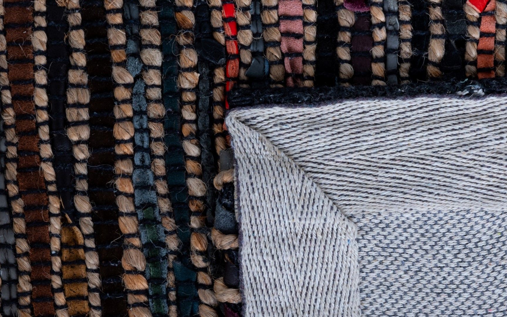 Rustic Charm Multi is a hand woven natural jute and leather carpet.  Colour Black with a multi colour accents. Sizes 155 X 225, 200 X 290, 240 X 320 and 300 X 400. Fold.
