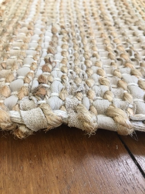 Rustic Charm Natural is a hand woven natural jute and leather carpet.  Colour Natural Jute with a beige/grey leather accents. Sizes 200 X 290, 240 X 320 and 300 X 400. Side.