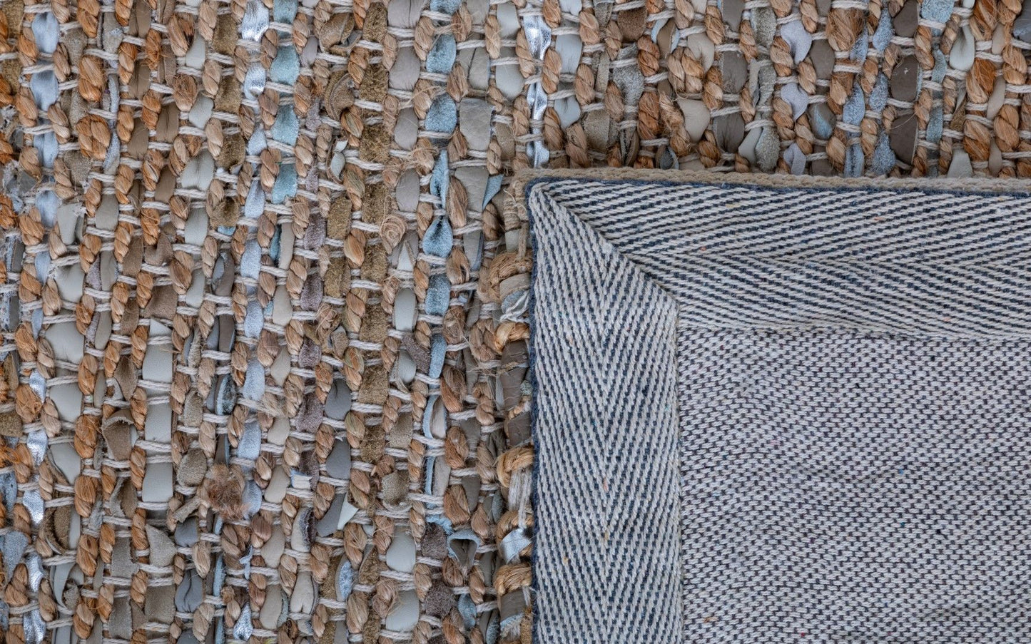 Rustic Charm Natural White is a hand woven natural jute and leather carpet.  Colour Natural Jute with a Blue, beige and grey leather accents. Sizes 200 X 290, 240 X 320 and 300 X 400. Fold.