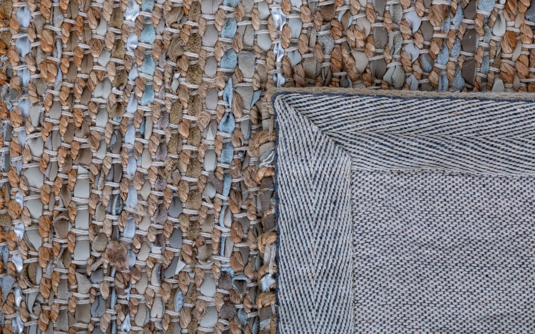 Rustic Charm Natural White is a hand woven natural jute and leather carpet.  Colour Natural Jute with a Blue, beige and grey leather accents. Sizes 200 X 290, 240 X 320 and 300 X 400. Fold.