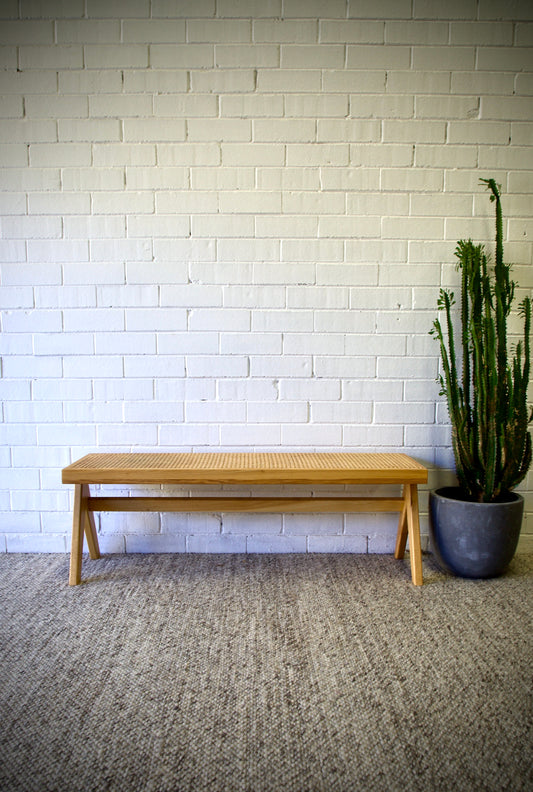 The Saffron Bench is a contemporary coastal bench. It is crafted with a beechwood frame and rattan seat. Colour natural. Measures 1200 wide X 360 depth X 400 height. Front Styled.