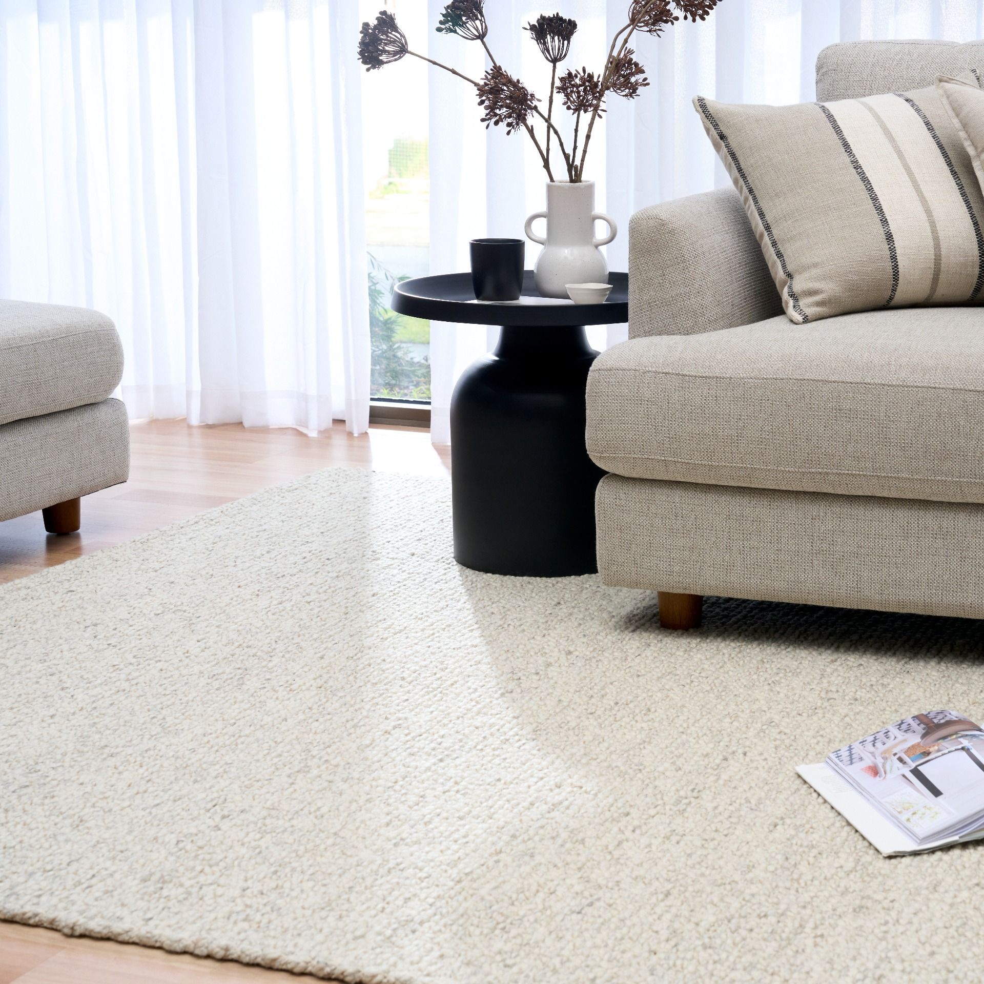 Sahara Grey Rug – hand woven 100% wool rug in soft neutral tones with a textured finish, available in three sizes, styled for modern and coastal homes. Styled.
