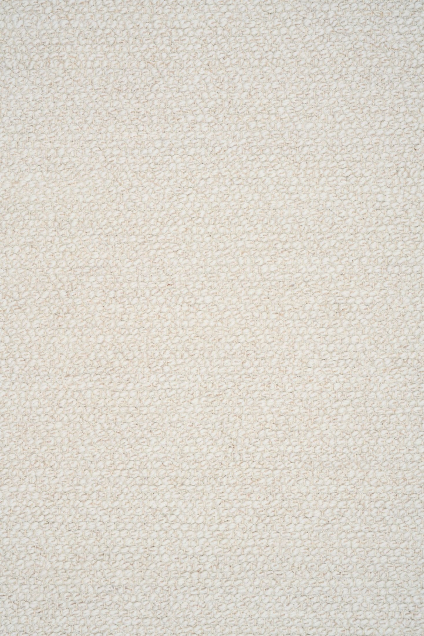 Sahara Ivory Rug – hand woven 100% wool rug in soft neutral tones with a textured finish, available in three sizes, styled for modern and coastal homes. Close.