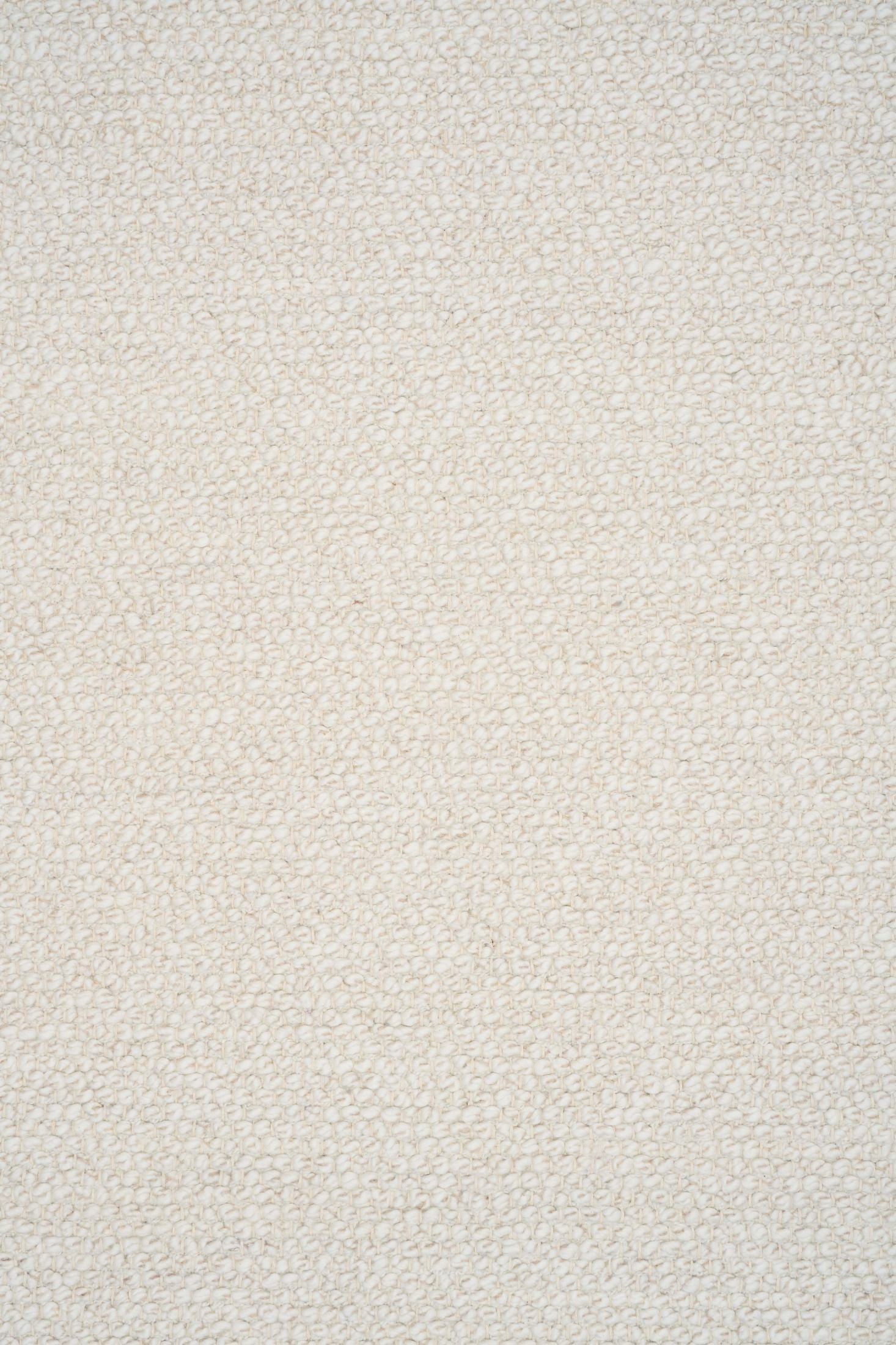 Sahara Ivory Rug – hand woven 100% wool rug in soft neutral tones with a textured finish, available in three sizes, styled for modern and coastal homes. Close.