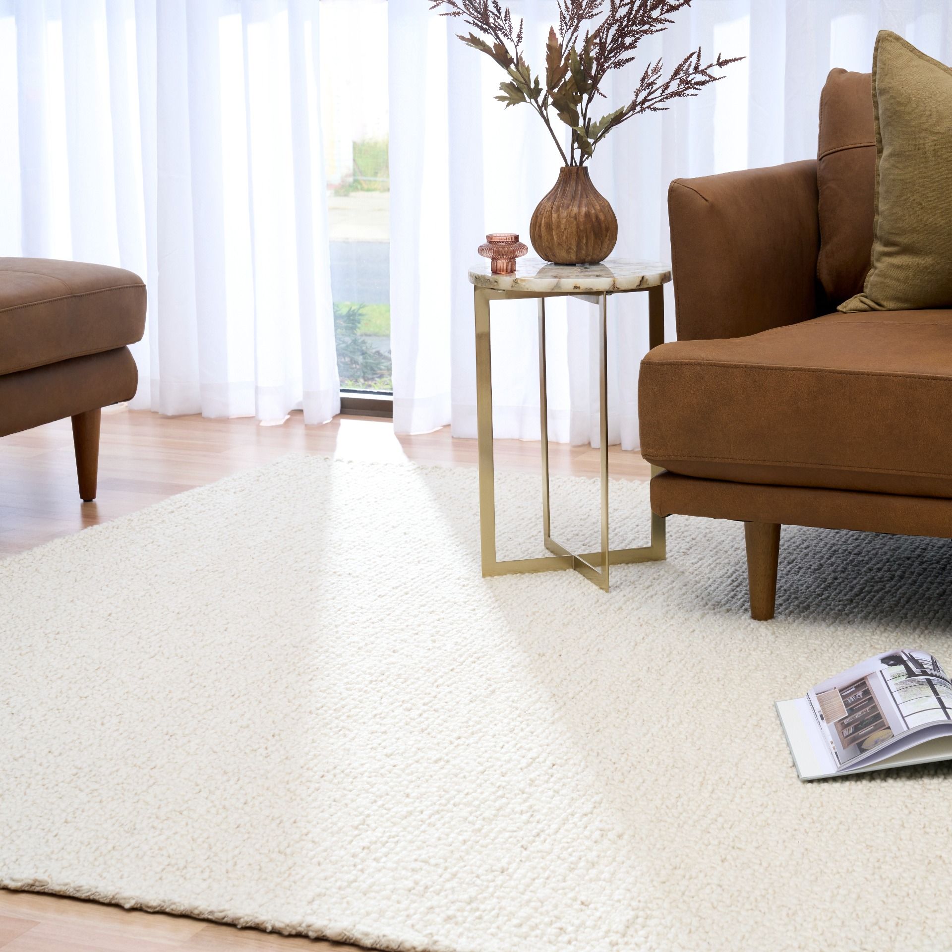 Sahara Ivory Rug – hand woven 100% wool rug in soft neutral tones with a textured finish, available in three sizes, styled for modern and coastal homes. Styled.