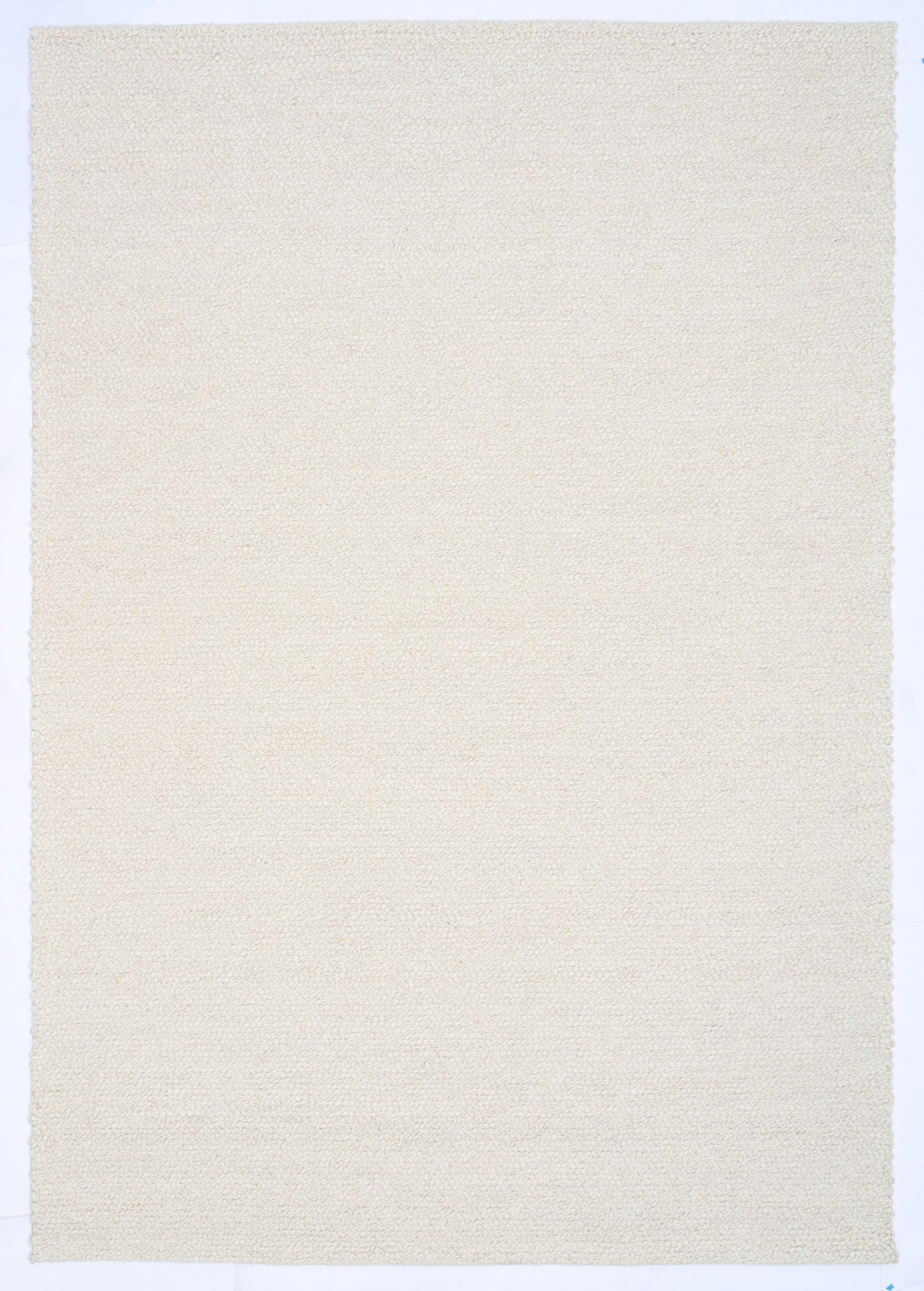 Sahara Ivory Rug – hand woven 100% wool rug in soft neutral tones with a textured finish, available in three sizes, styled for modern and coastal homes. Top.