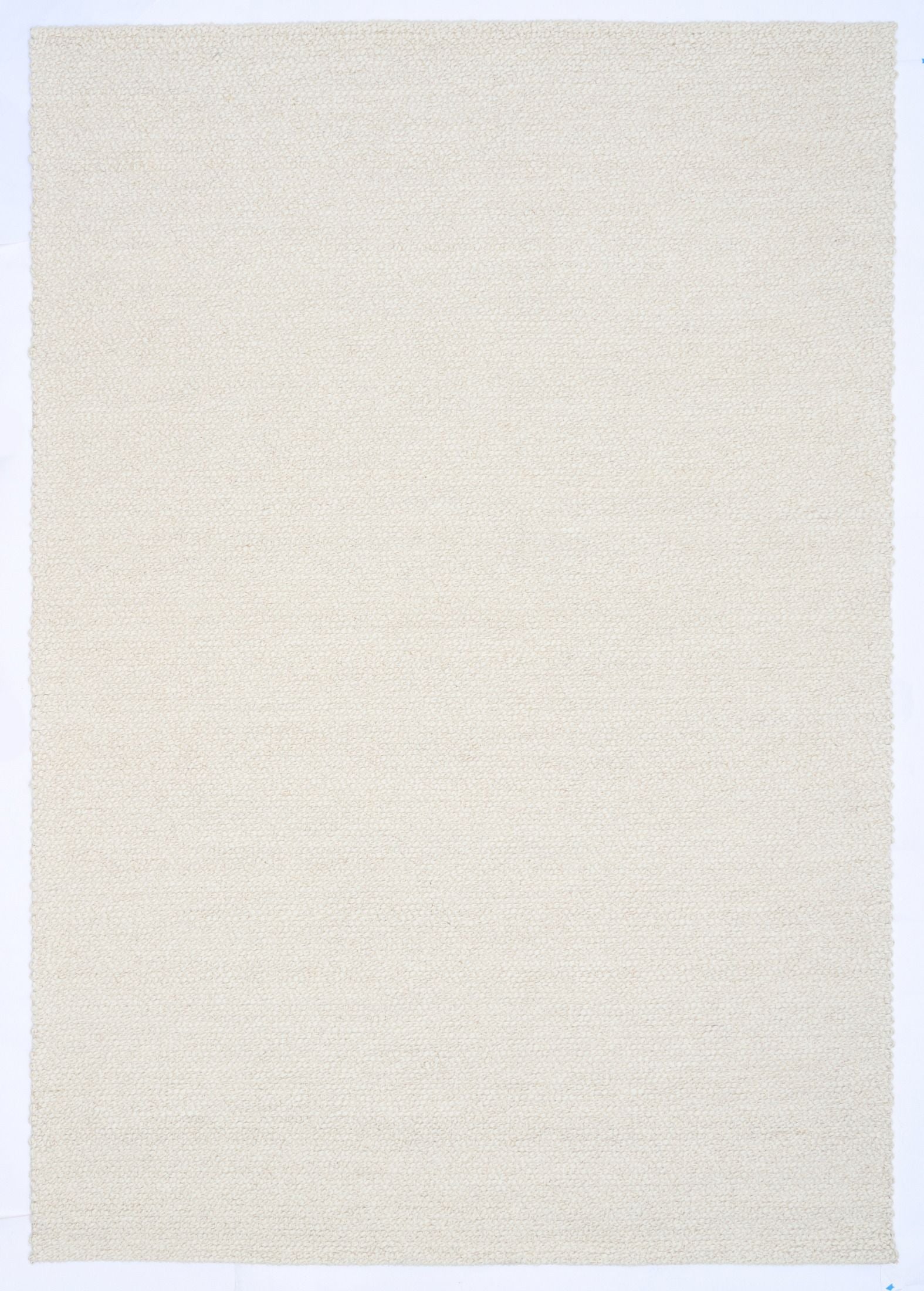 Sahara Ivory Rug – hand woven 100% wool rug in soft neutral tones with a textured finish, available in three sizes, styled for modern and coastal homes. Top.